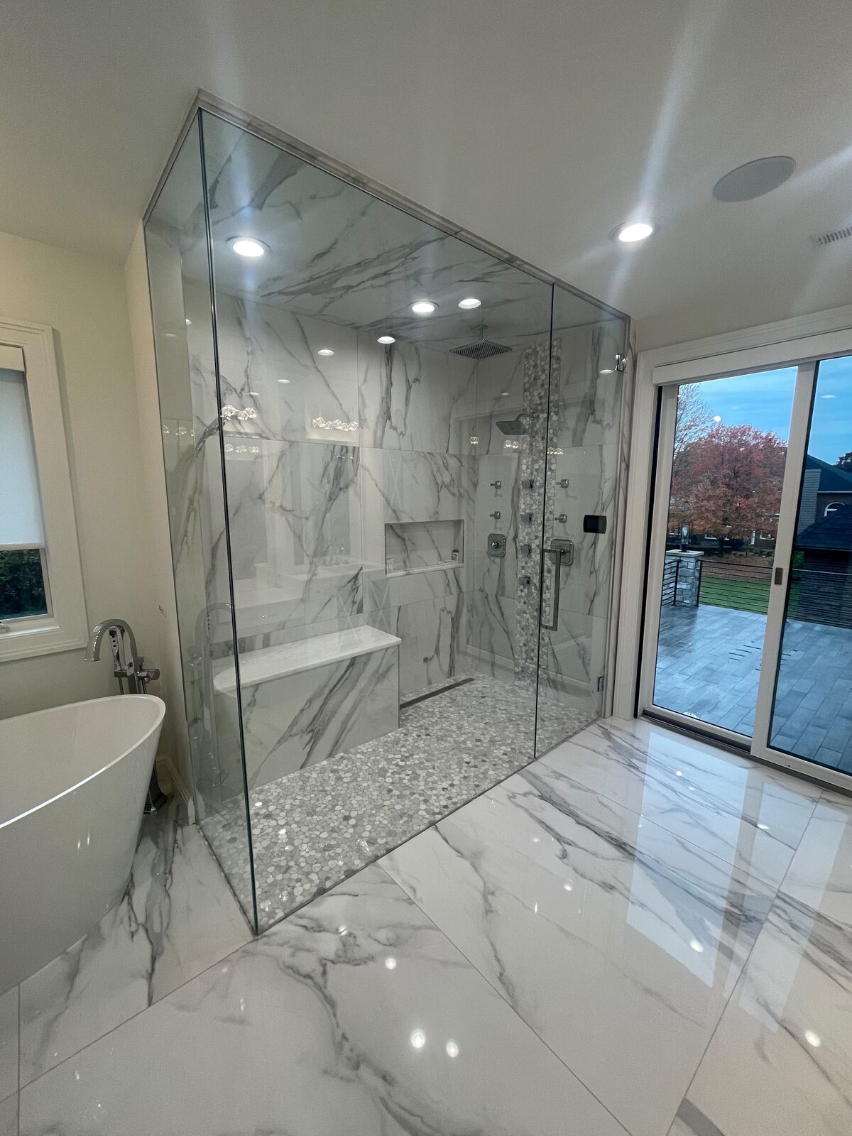Frameless glass shower enclosure with a deck view