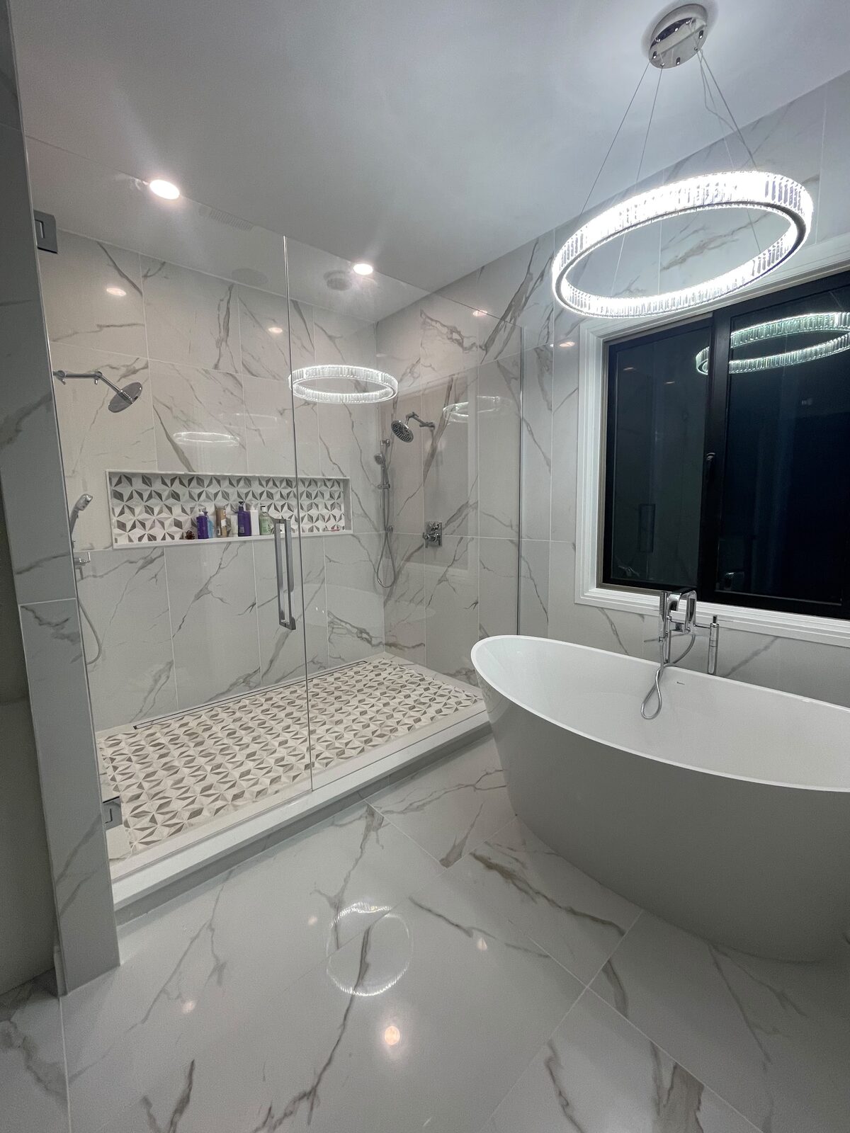 Frameless glass shower with ring light and marble