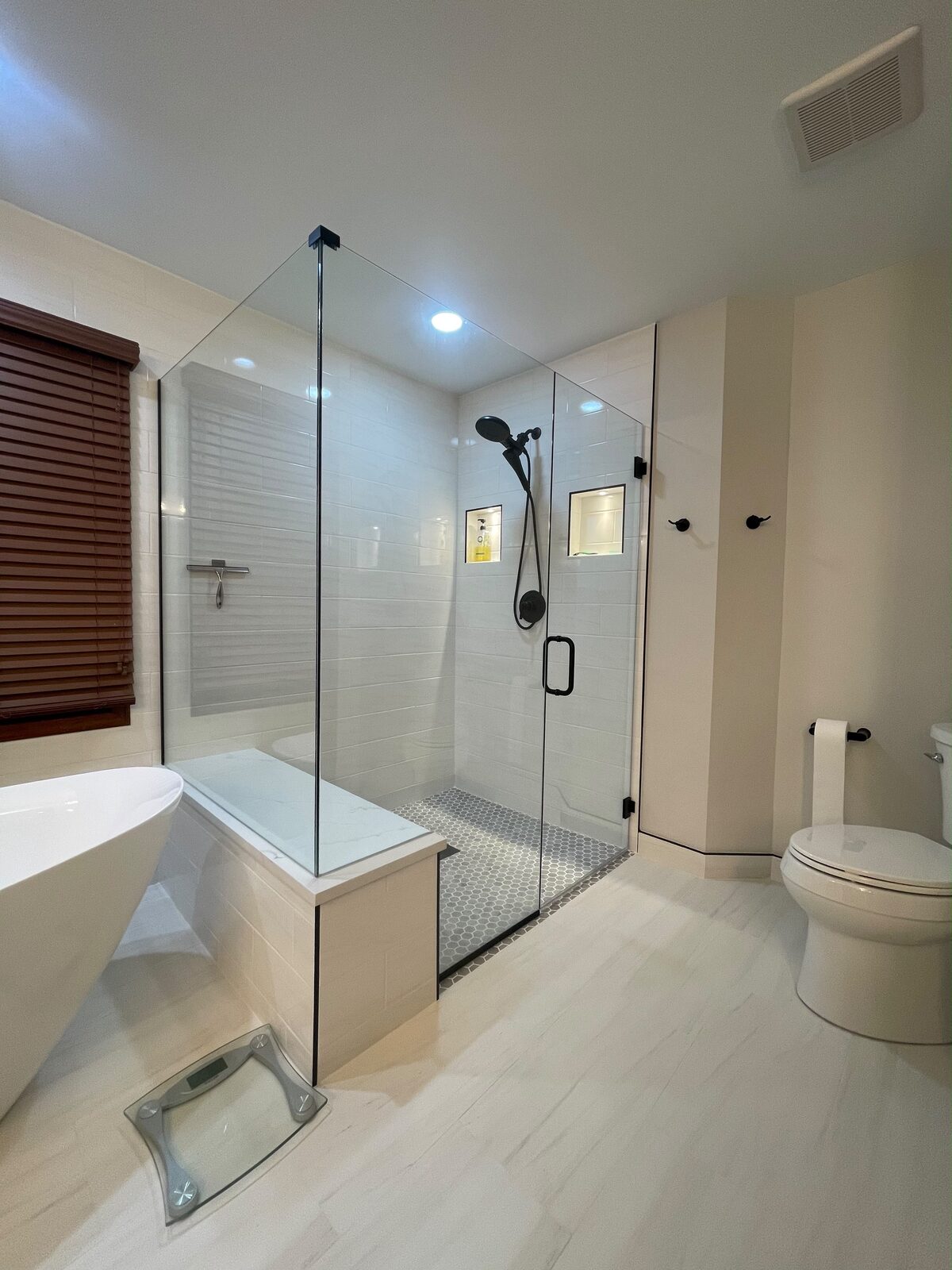 Frameless glass shower with subway tile and tub