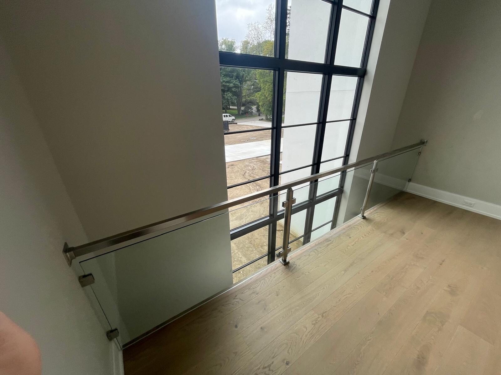 Exterior glass deck railing with stone staircase