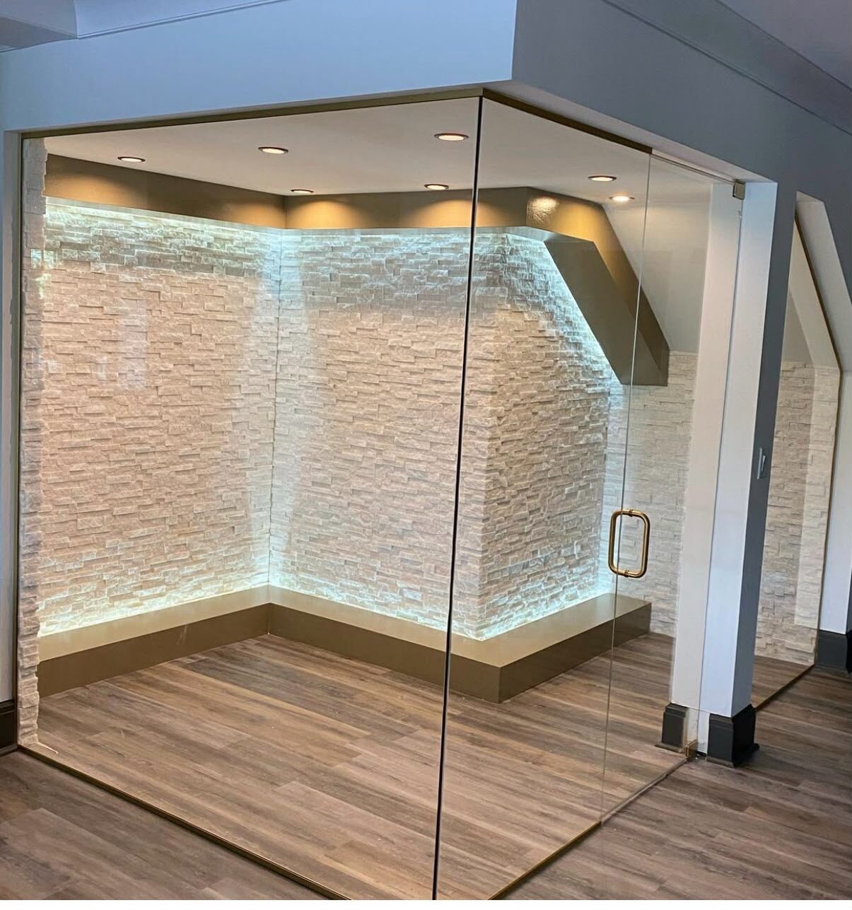 Glass-enclosed stone feature room