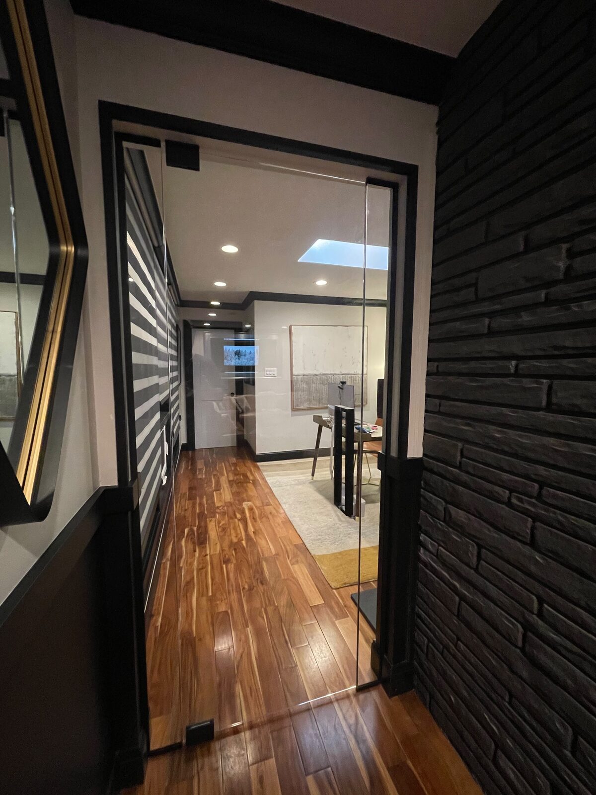 Glass office door beside a stone wall