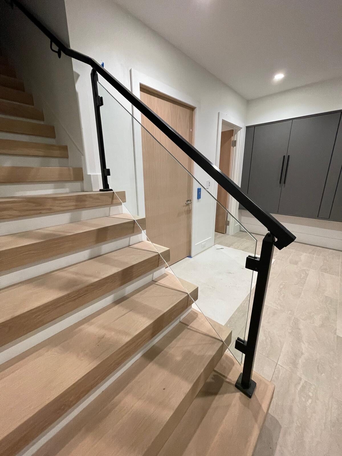 Floating stairs with glass railing and black posts