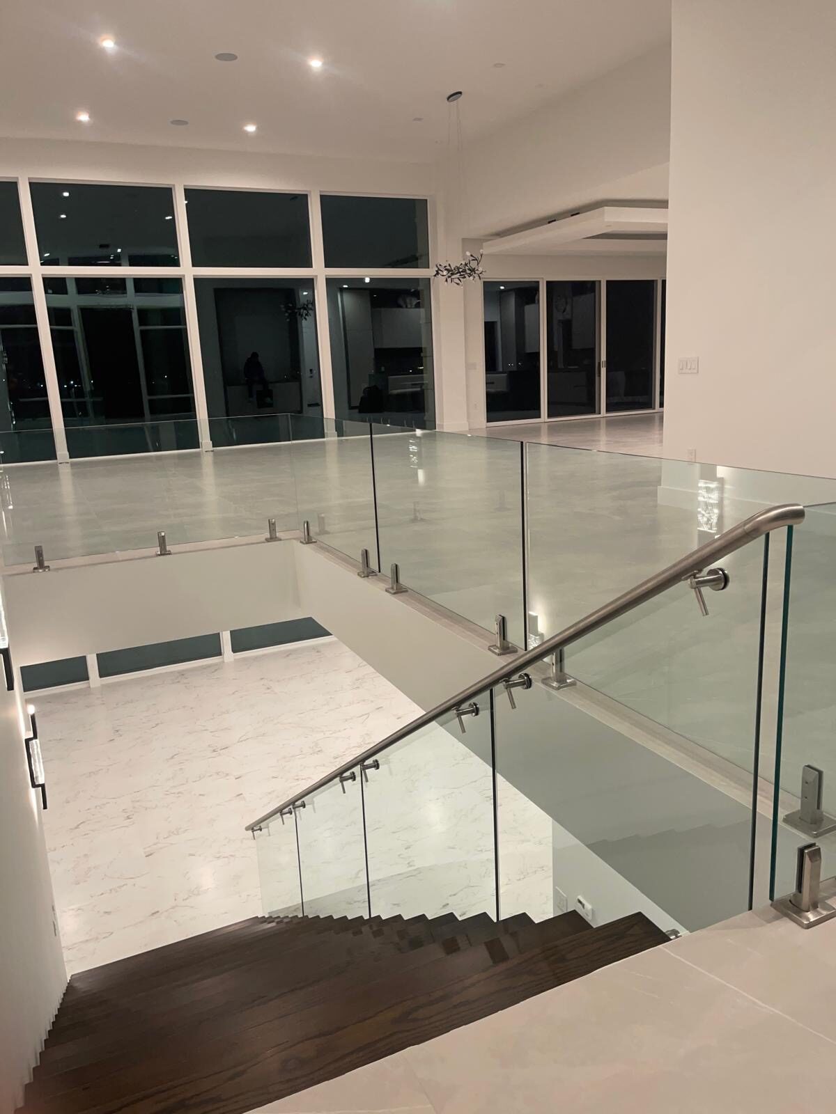 Stainless glass railing on a landing at night
