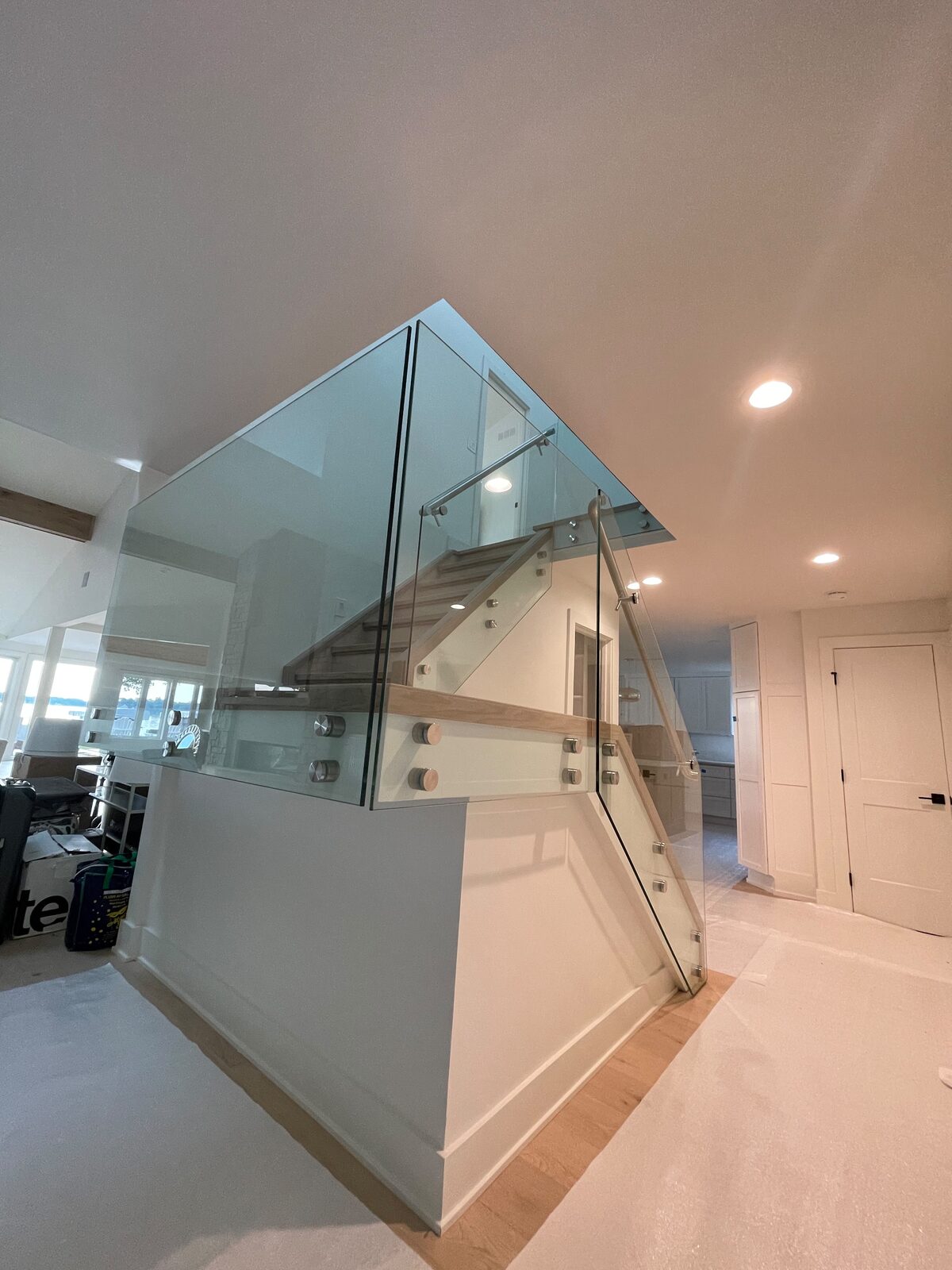Glass railing staircase with a lake view