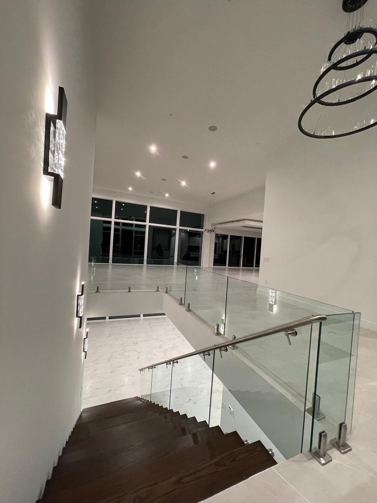 Glass railing over a great room at night
